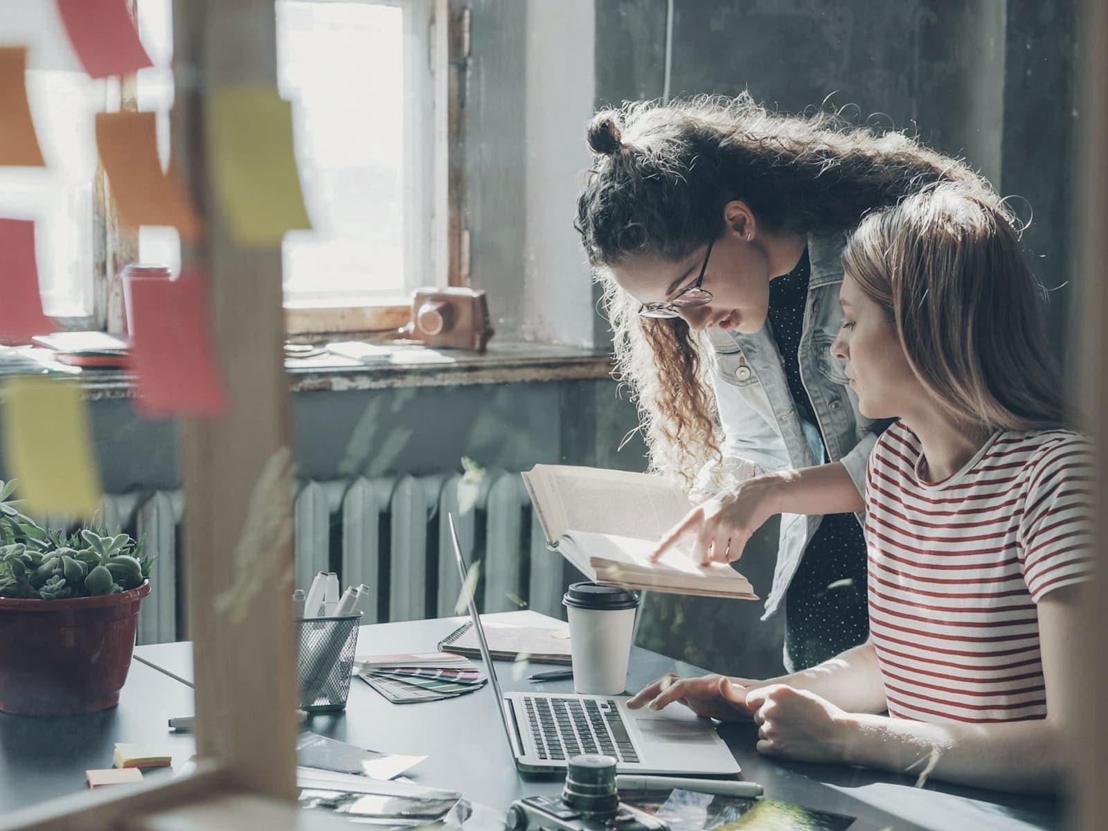 Two people going over work together at a laptop
